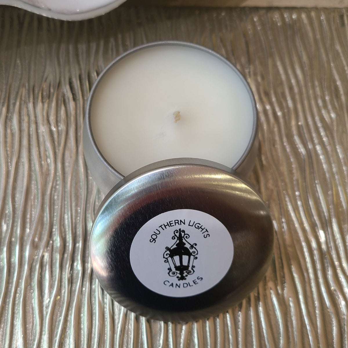 scented candle in round silver travel tin