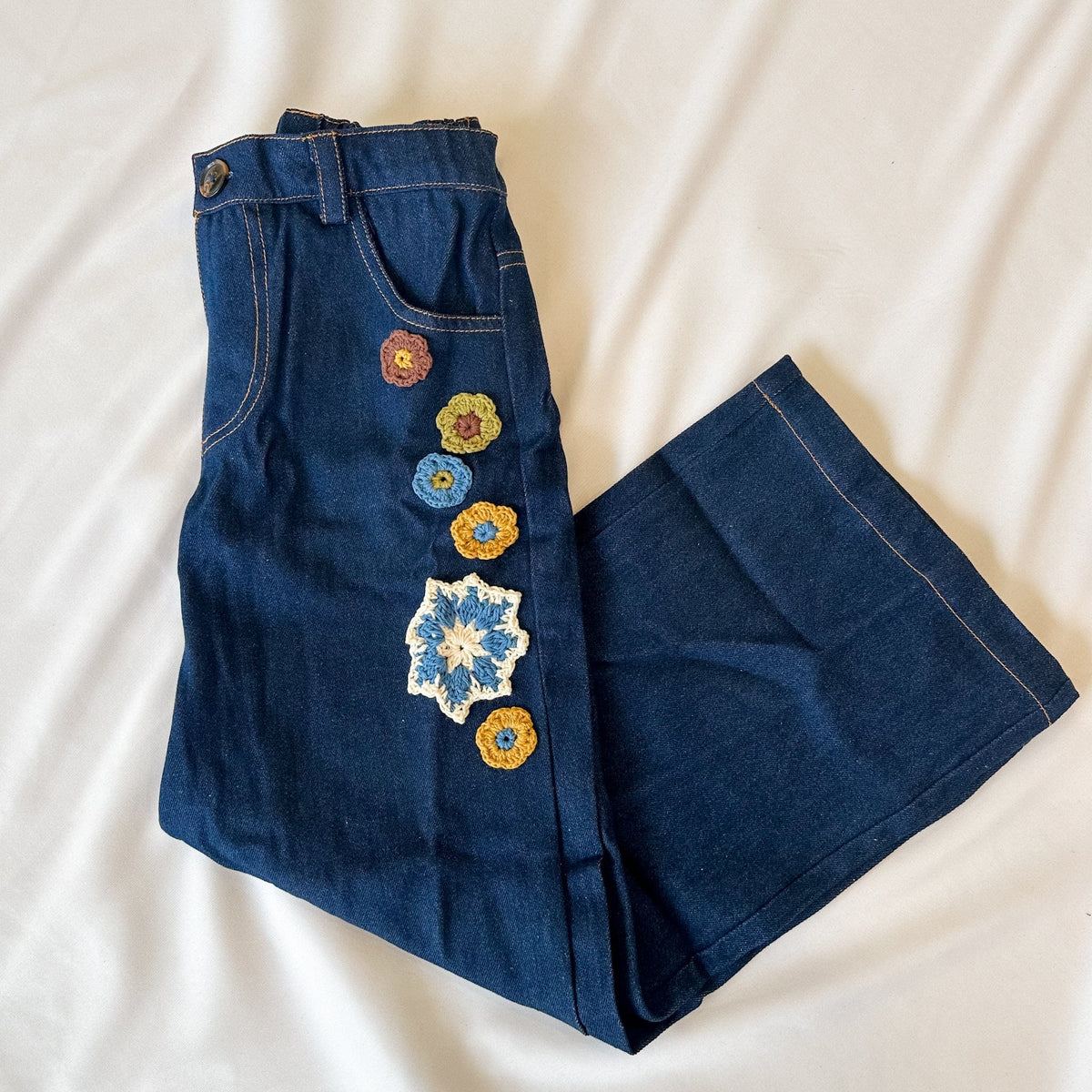 Blue denim shorts with colorful floral embroidery