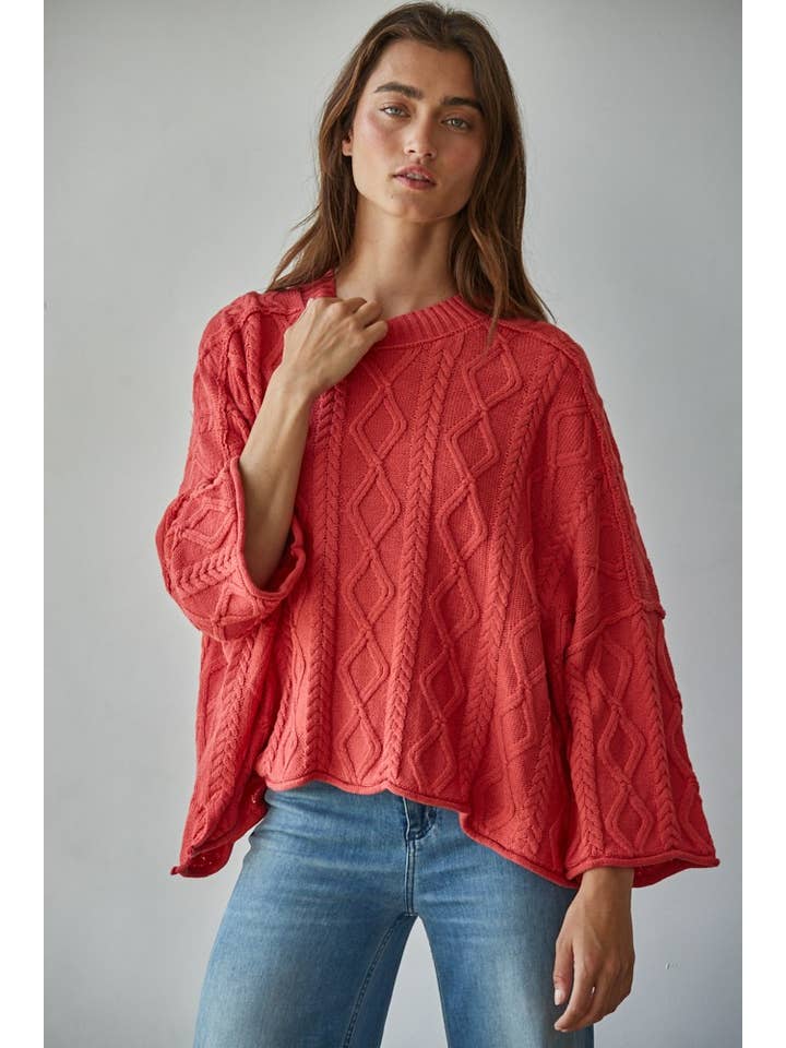 red cable knit sweater with side slits