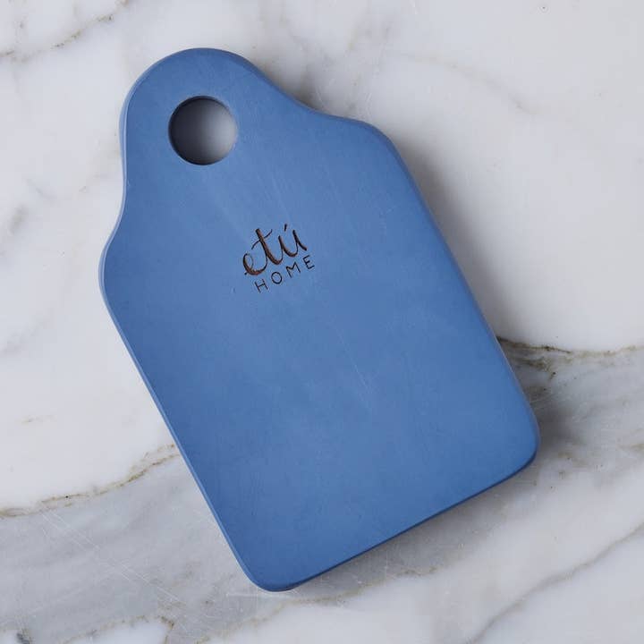 Blue cutting board with 'etu HOME' branding on a marble surface