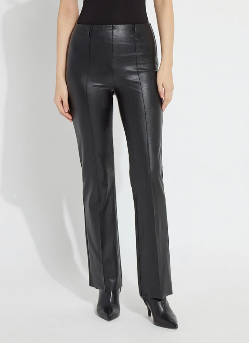 Woman wearing Ellie black textured vegan leather straight leg pants with pointed-toe boots