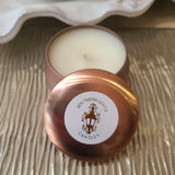 scented round candle in rose gold travel tin