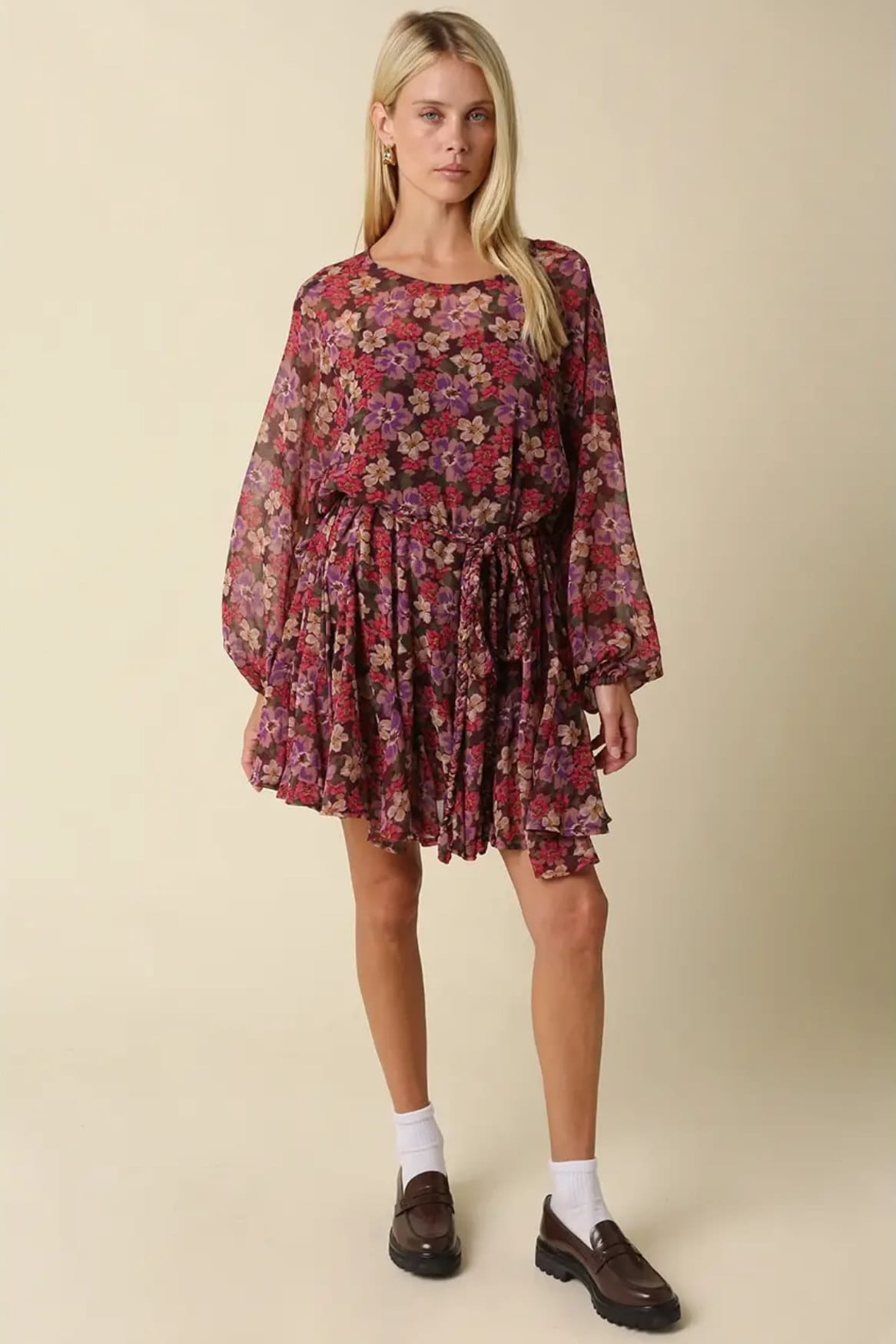 Model wearing the Emily burgundy floral mini dress with brown loafers and white socks