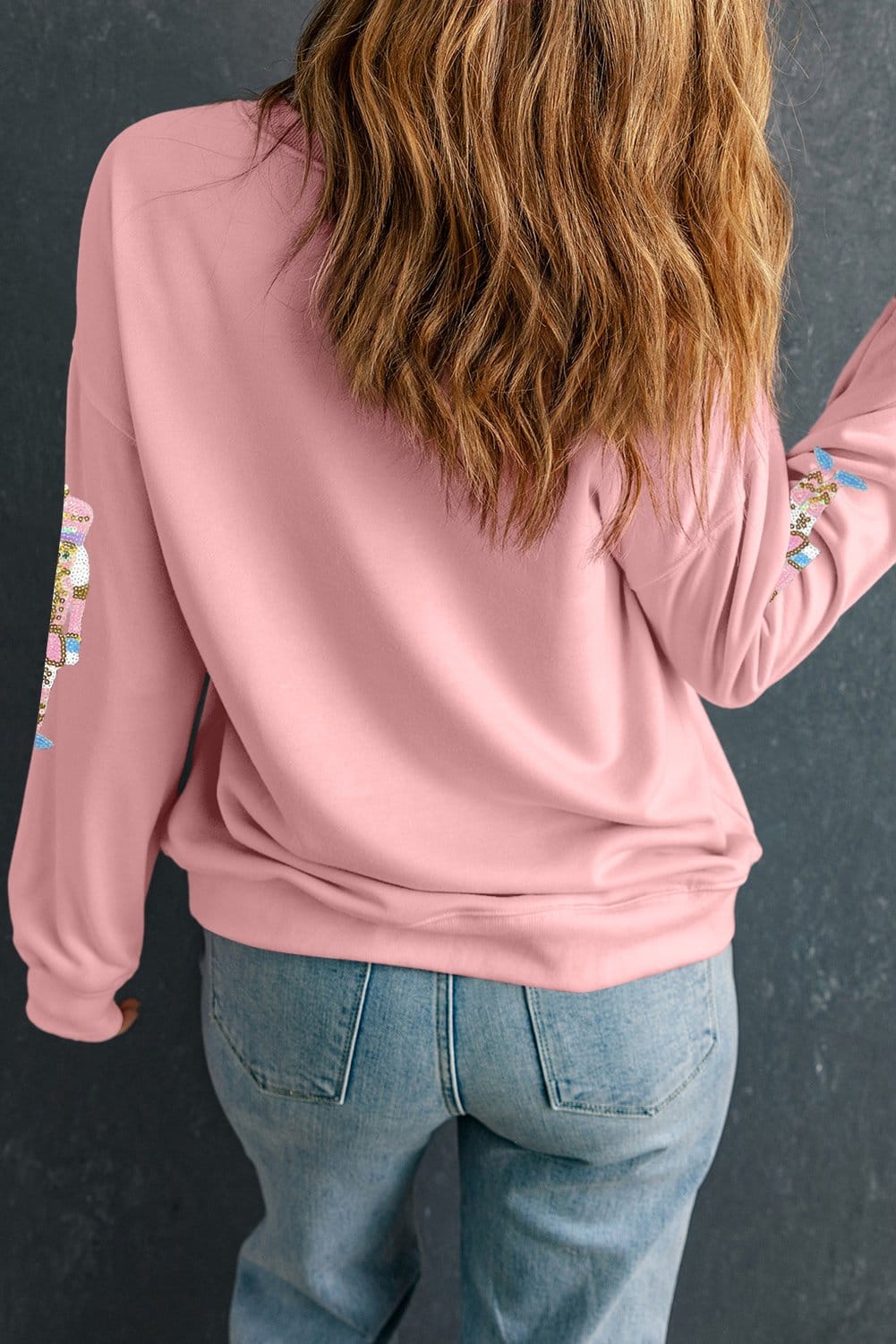 back of pink sequin nutcracker sweater