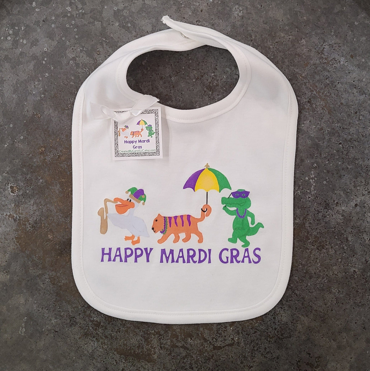 Created by Carol LLC Created by Carol Happy Mardi Gras Pelican, Tiger Gator Knit Bib - Little Miss Muffin Children & Home