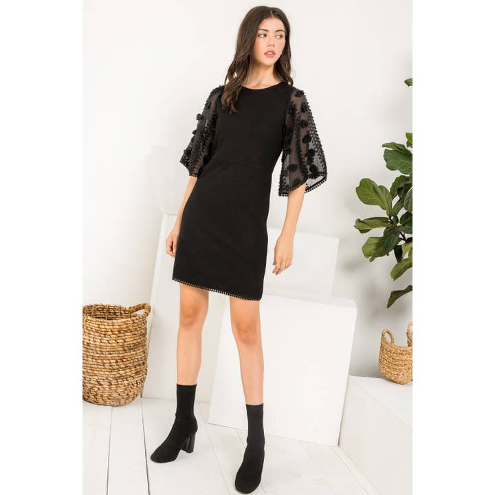 black mini dress with sheer sleeve