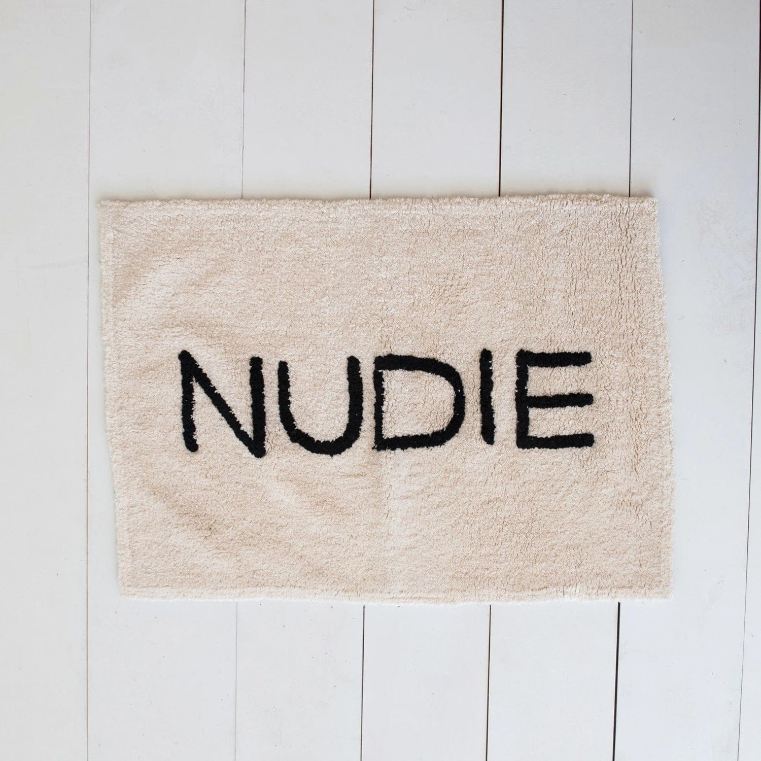 Creative Co-op Creative Co-op 40"L x 27"W White Cotton Tufted Bath Mat with "NUDIE" in Black - Little Miss Muffin Children & Home
