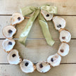 oyster wreath with green ribbon