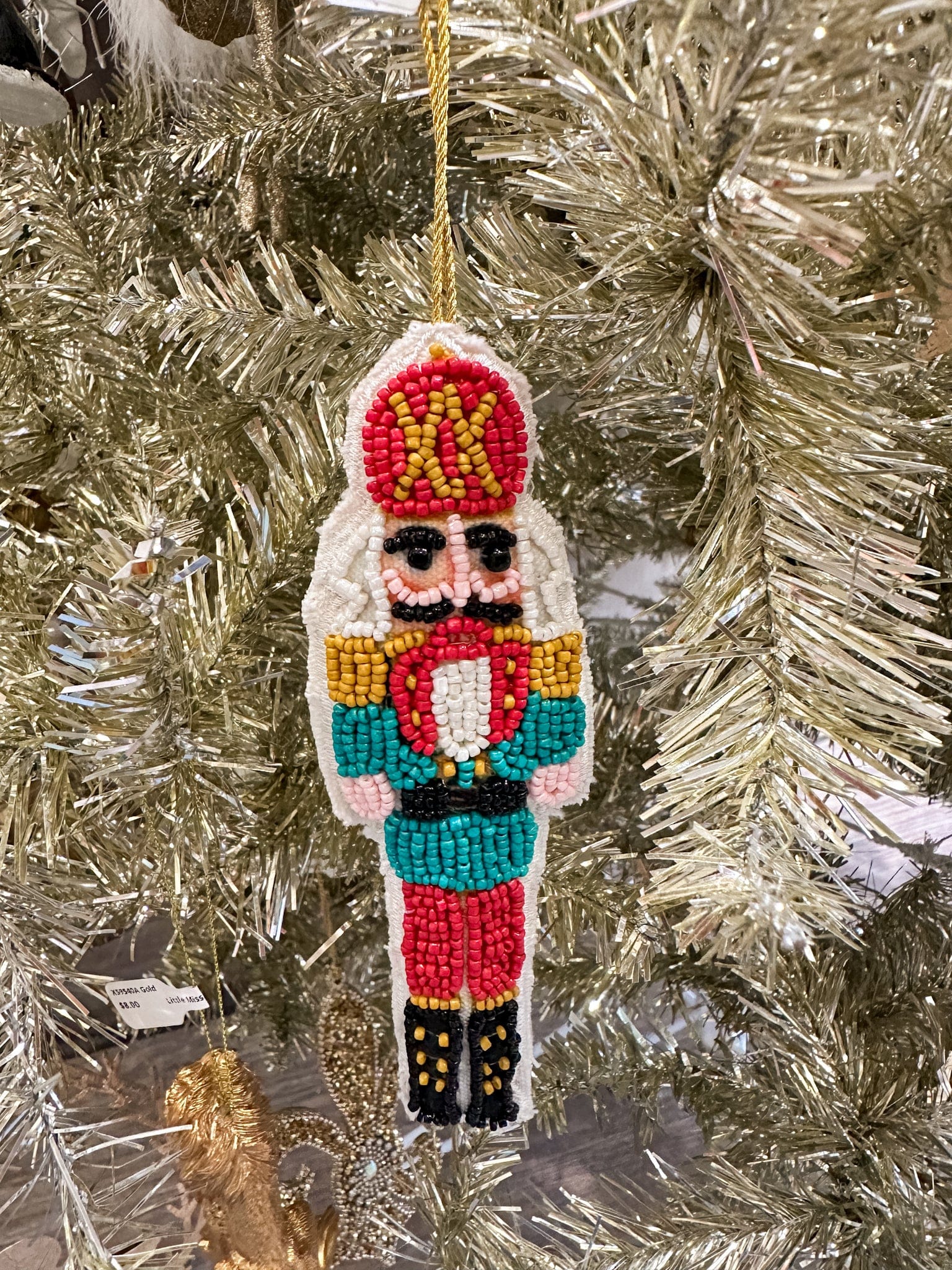 red and gold hat nutcracker ornament